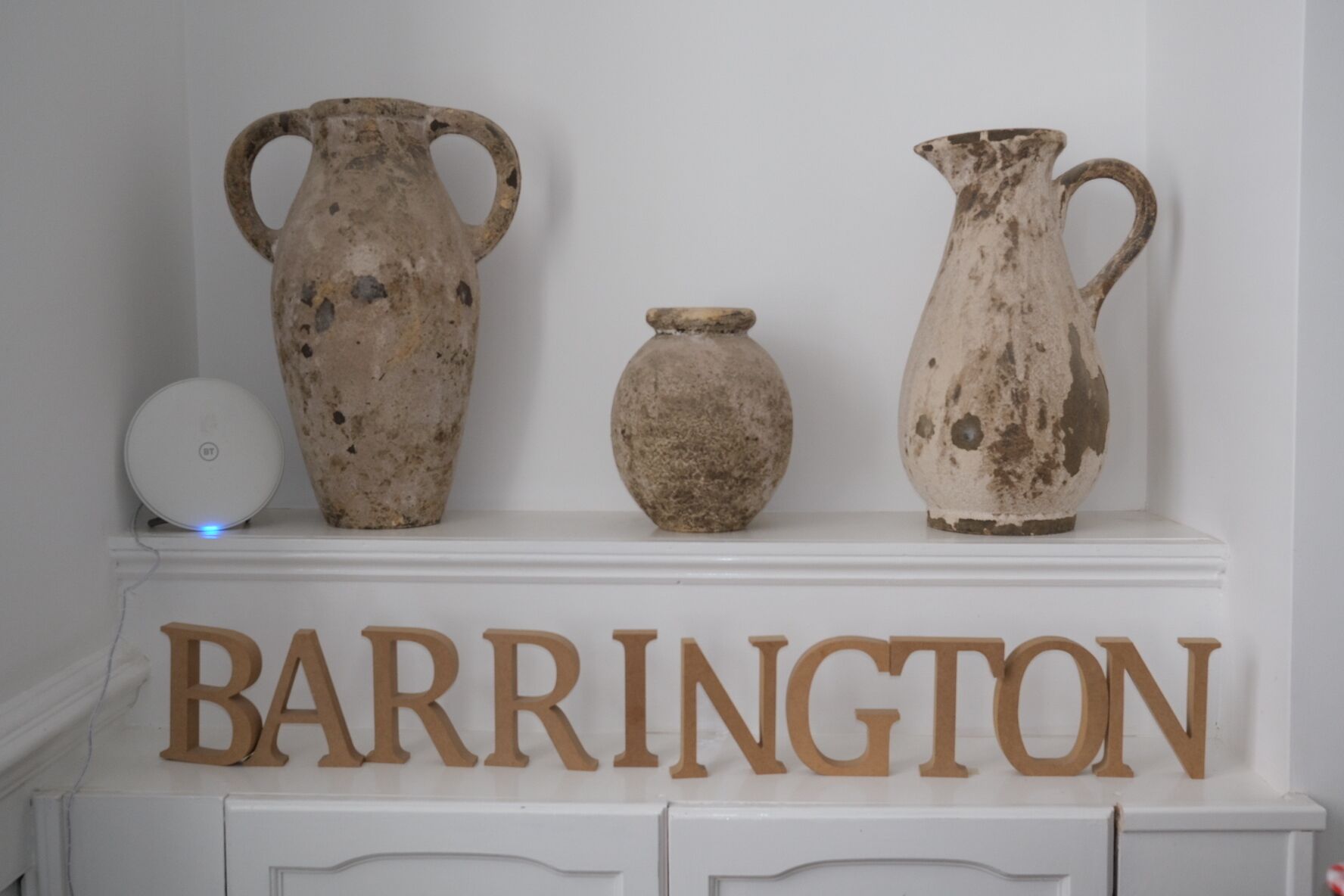 Three pottery pieces on a shelf with the word "BARRINGTON" below them.