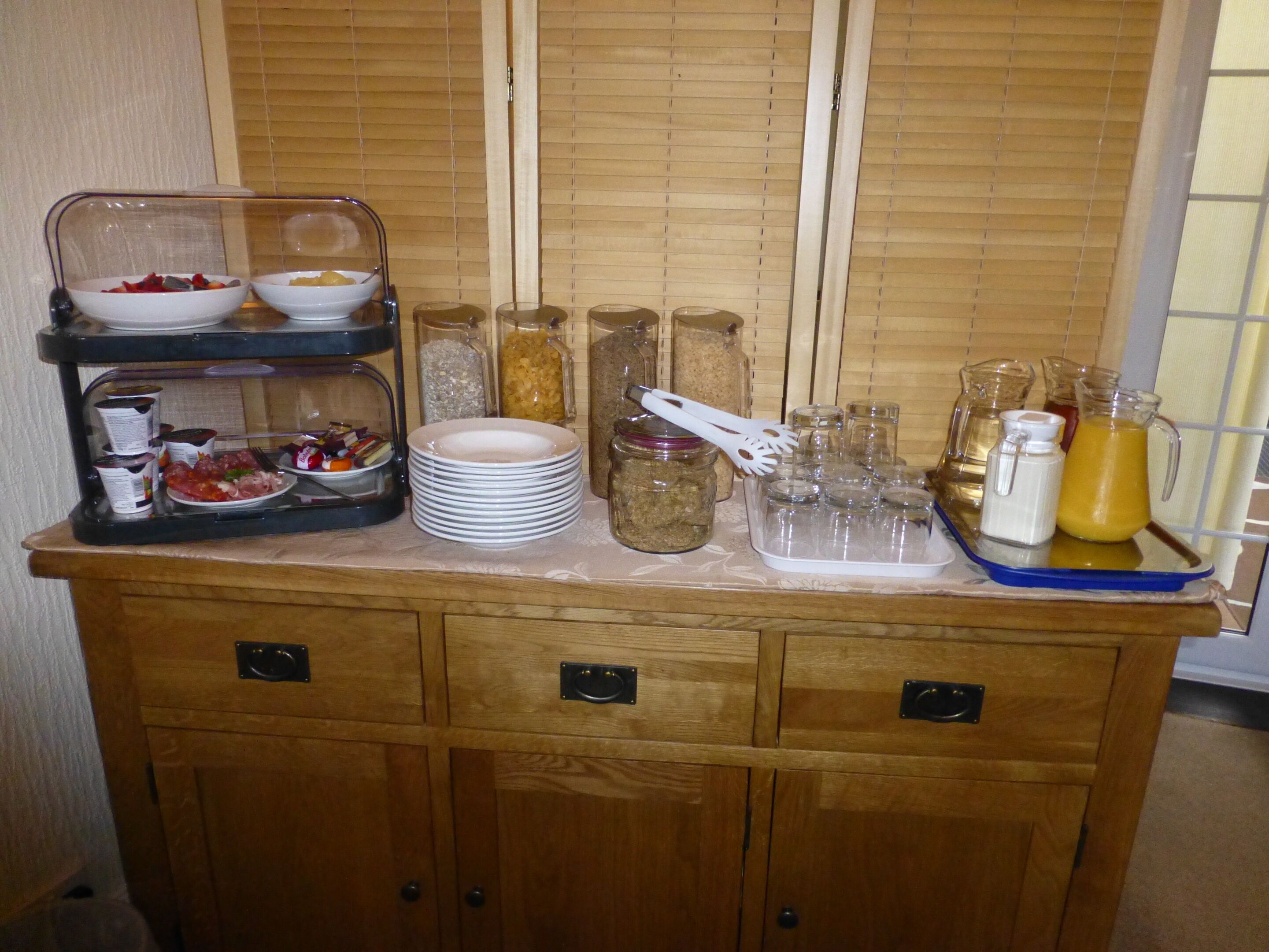 A buffet setup with various food items and condiments.