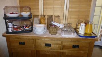 A buffet setup with various food items and condiments.