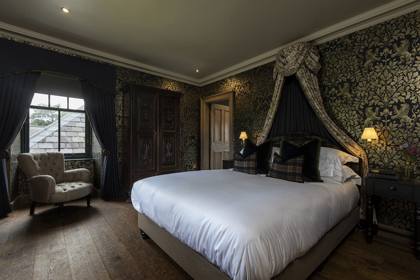 A spacious bedroom with a large bed, a chair, and a window.