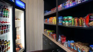 A refrigerated section with various beverages and snacks.