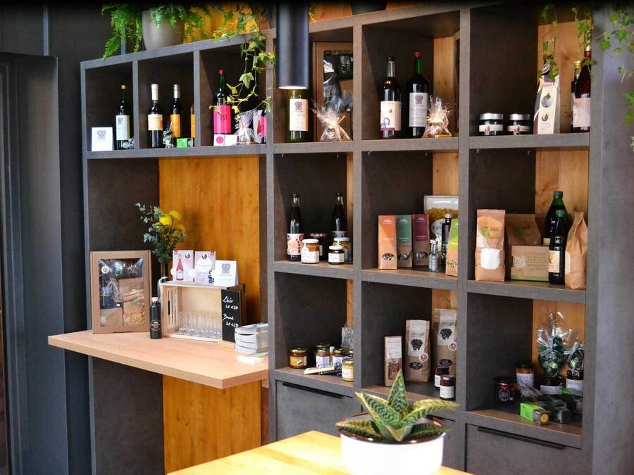 A wine and gift shop with shelves stocked with wine bottles, gift boxes, and various packaged items.