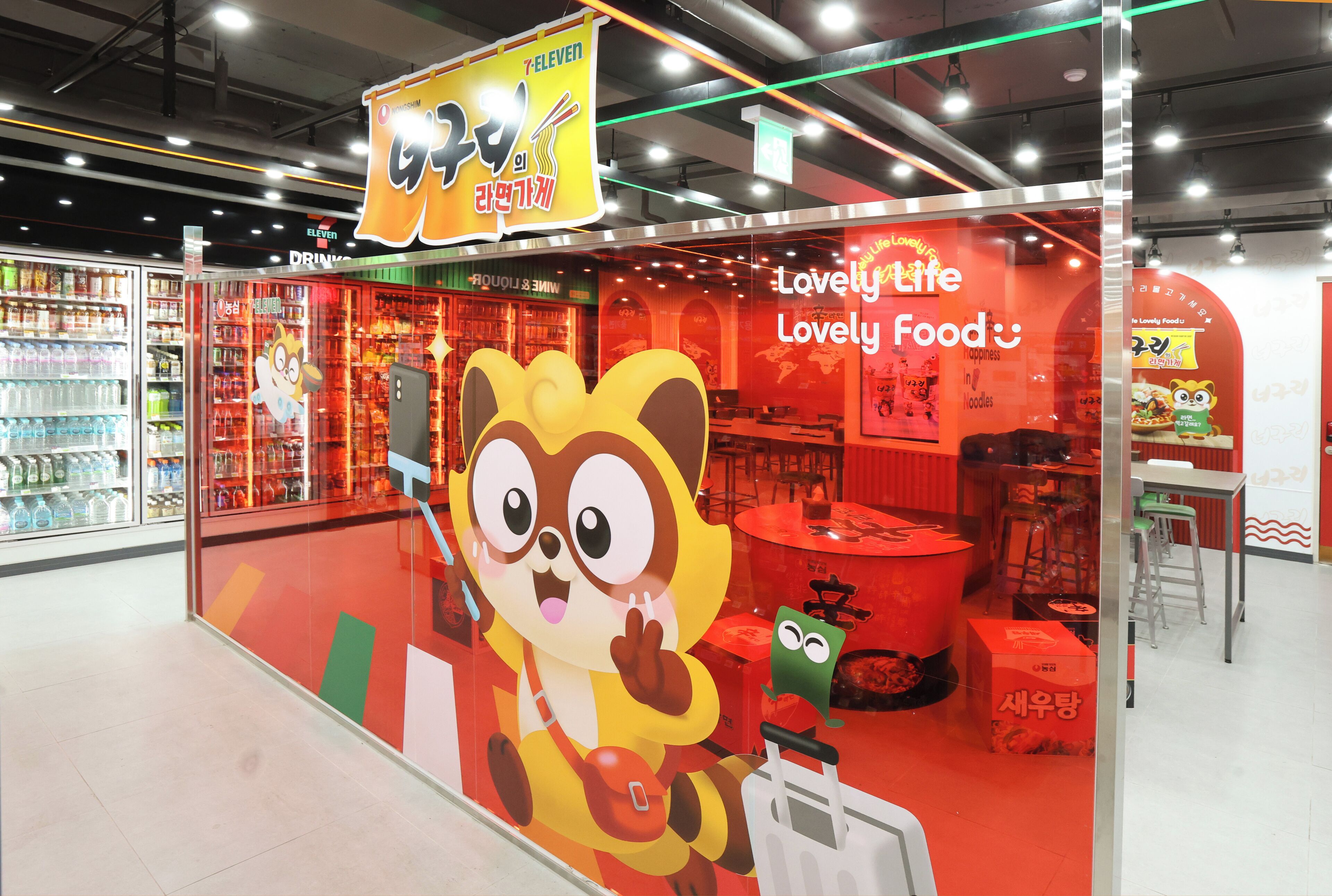 A brightly lit 7-Eleven store with a large cartoon character on the window.