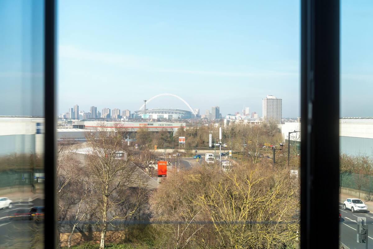 A view of a cityscape with a large stadium and modern buildings.