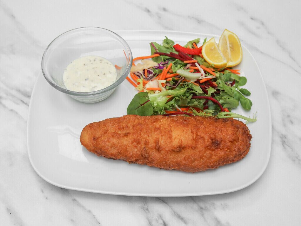A plate with a breaded and fried item, a salad with mixed greens and carrots, and a small bowl of sauce, all on a white plate.