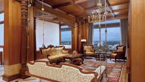 Ein luxuriöses Zimmer mit einem großen Bett, aufwendigen Möbeln und Blick auf die Stadt.