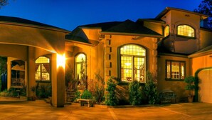 A two-story house with a covered porch, large windows, and a garage. - Bella Vista Bed and Breakfast (Placerville)