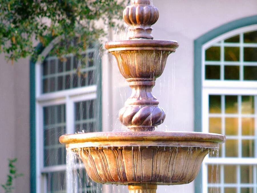 A multi-tiered fountain with water flowing from the top tier.