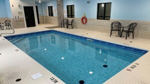A swimming pool with a 13.7m depth, surrounded by tiled walls and a ceiling with recessed lighting.