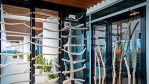 A modern building entrance with natural wood elements and a glass door.