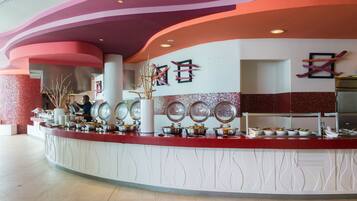 A buffet area with multiple serving stations, a central pillar, and decorative wall elements.
