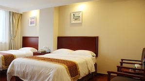A hotel room with two beds, a wooden headboard, a chair, and a small table with a phone and a lamp. - Greentree Jiangsu Yizheng East Zhenzhou (Yangzhou)