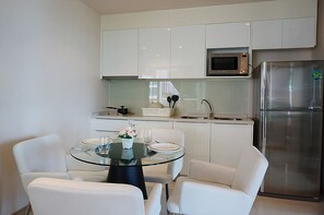 Suite, 1 Bedroom, Garden View | Private kitchenette | Fridge, stovetop, electric kettle, dining tables