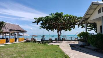 On the beach, white sand, sun loungers, beach umbrellas