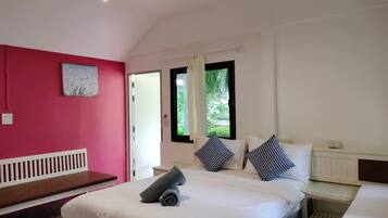 A bedroom with a bed, a bench, a window with curtains, and a painting on the wall.