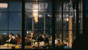 A restaurant with multiple tables and a hanging light fixture. - 14 Floor Hotel (Yerevan)