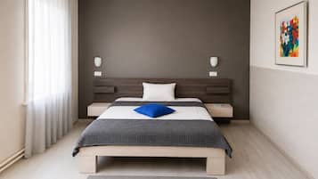 Un dormitorio moderno con cama, mesitas de noche, cabecera y un cuadro en la pared.