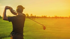 A person playing golf with a club in a field. - Blue Mist Motel Florence (Florence)