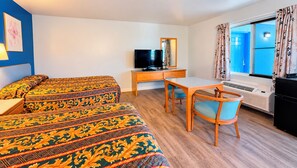 A hotel room with two beds, a desk, a chair, a television, and a window with curtains. - Blue Mist Motel Florence (Florence)