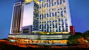 A high-rise hotel with a prominent 'Furama' sign, multiple floors, and a well-lit facade. - Furama Bukit Bintang (Kuala Lumpur)