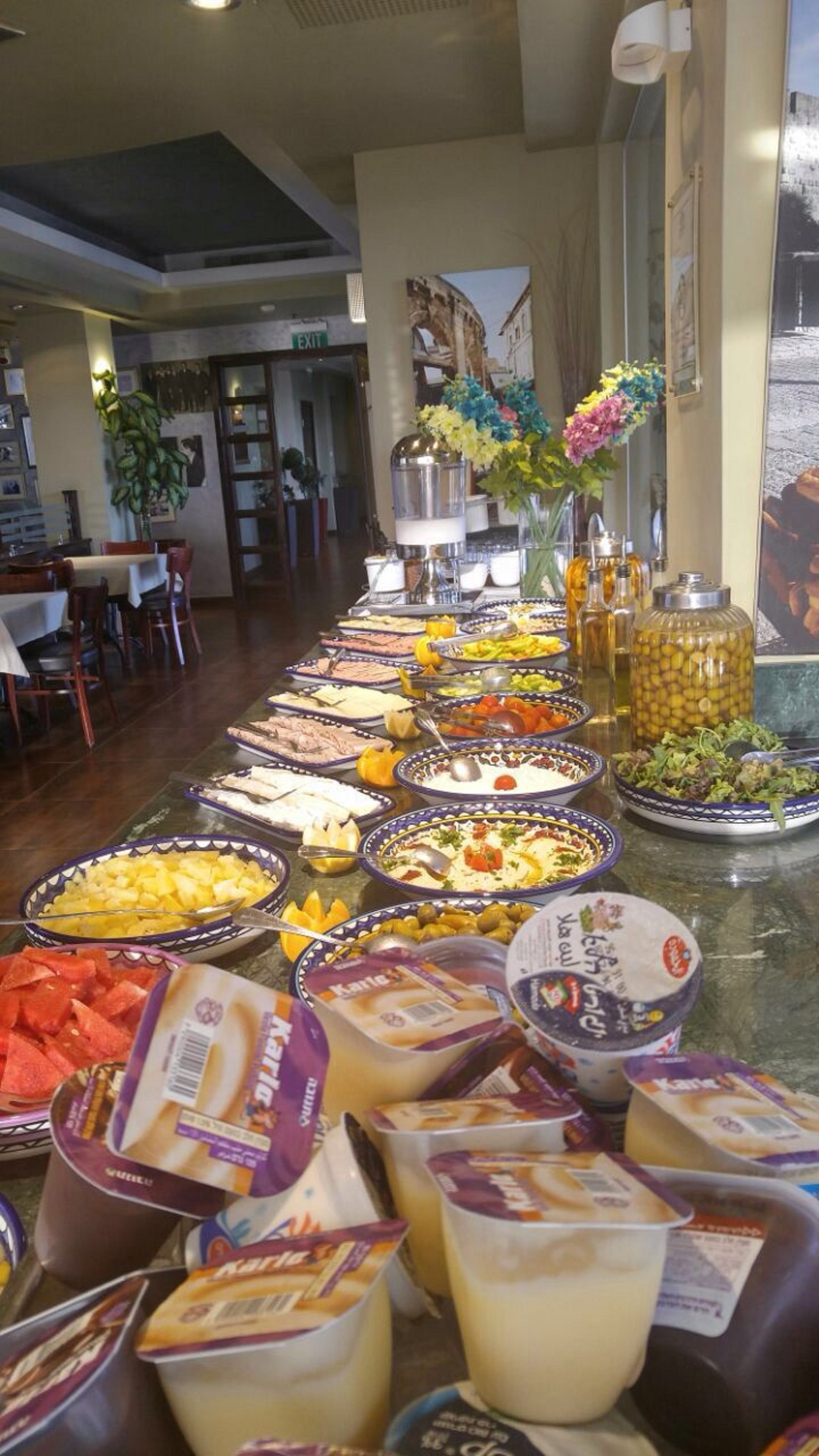 A buffet with various food items and dairy products.