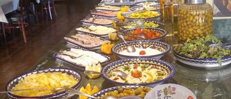 A buffet with various food items and dairy products.