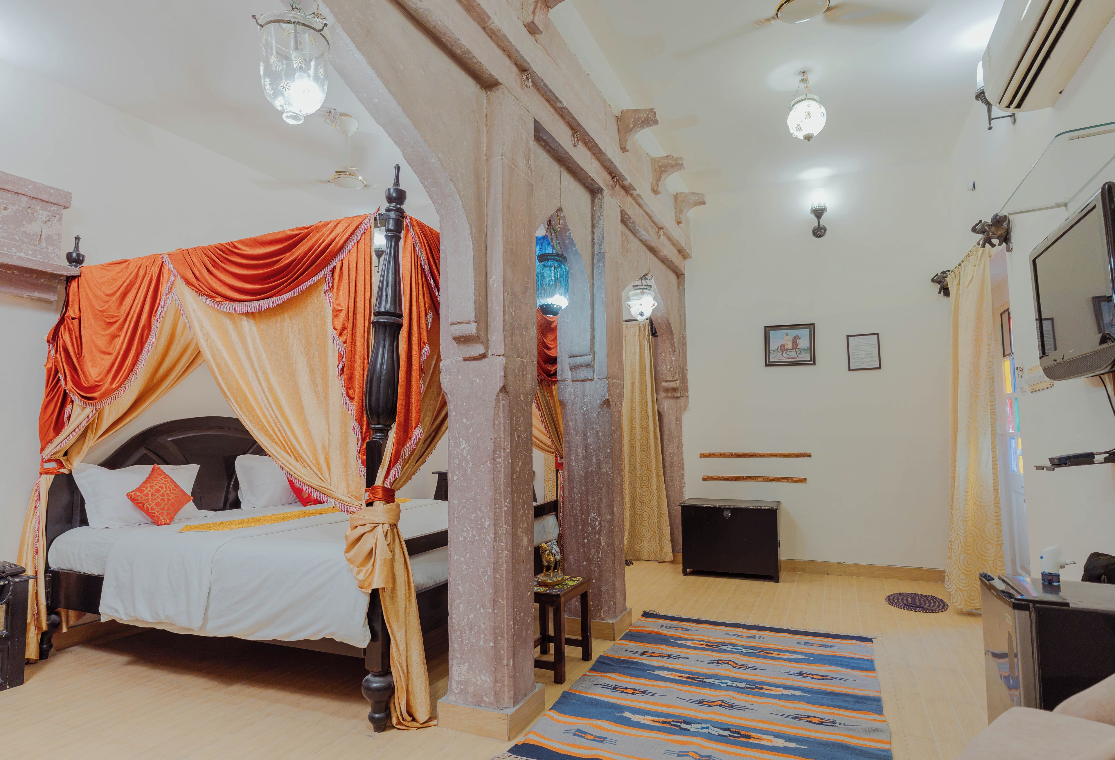 A room with a bed, a desk, and a mirror.