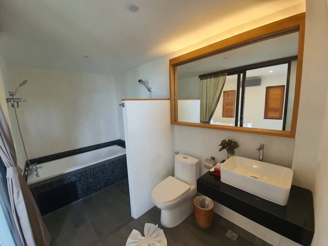 A modern bathroom with a bathtub, toilet, and sink.
