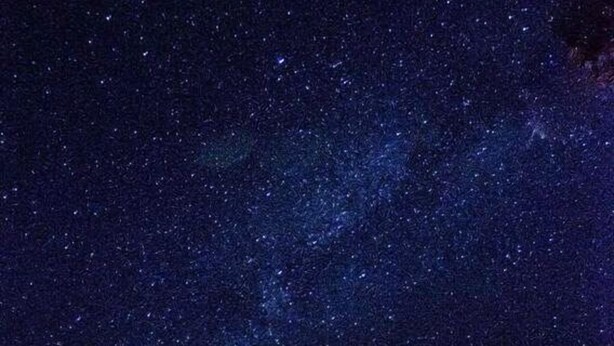 A house with a large window and a satellite dish under a starry night sky. - Emerald Trail (Nainital)