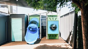 A compact outdoor area with a children's play structure, a water slide, and a green and blue washing machine-like structure. - The Sunnyside Tavern, Broadmeadow (Broadmeadow)