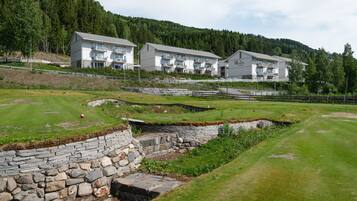 Set amidst a lush valley, this hotel offers a serene escape with a mix of flat and sloped roofs.