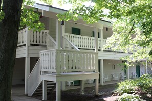 A two-story building with a balcony and a staircase.