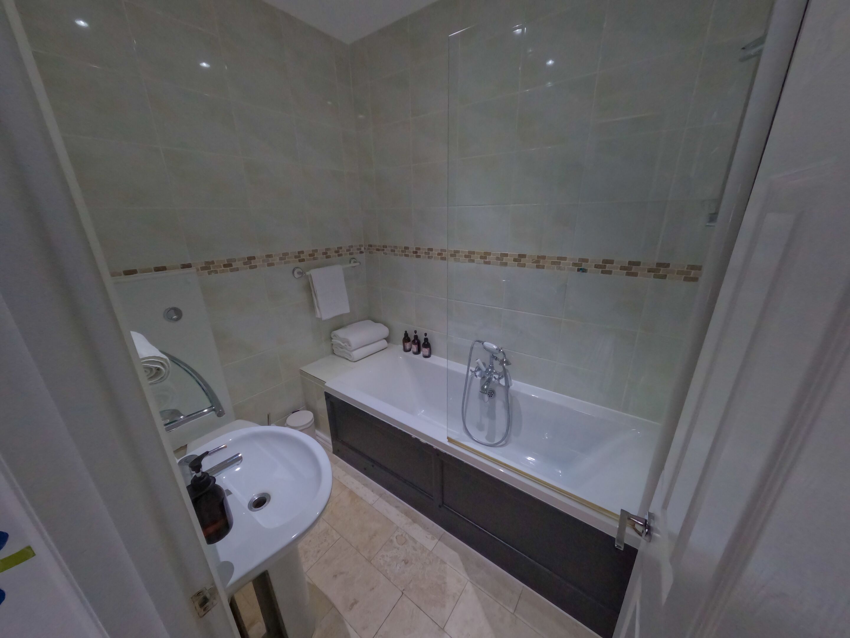 A bathroom with a bathtub, a sink, and a toilet.