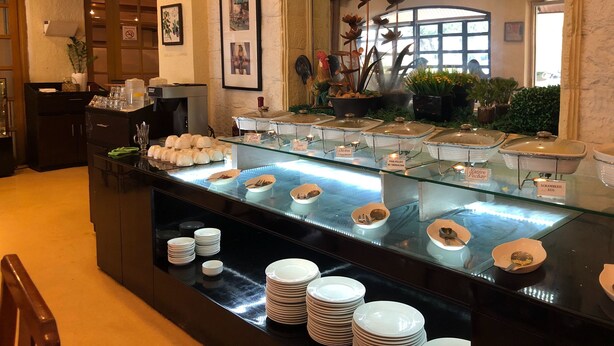 A buffet area with various food stations, including labeled sections for different dishes.