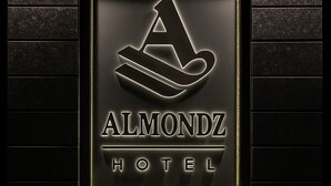 A hotel sign with a logo and the name 'Almondz Hotel'. - Almondz Hotel (New Delhi)