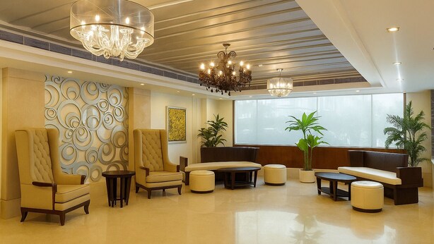 A spacious lobby with high ceilings, chandeliers, and a variety of seating options including armchairs and sofas. - Almondz Hotel (New Delhi)