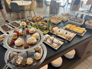 A buffet with various pastries, fruits, and desserts. - Canada Hotel (Budapest)