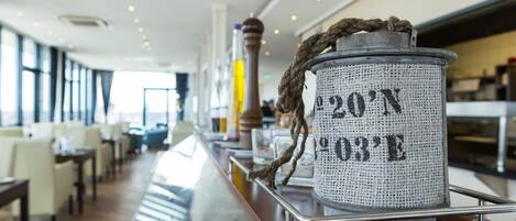 A bar area with a rustic-looking container labeled "20'N 03'E" on a wooden bar counter.