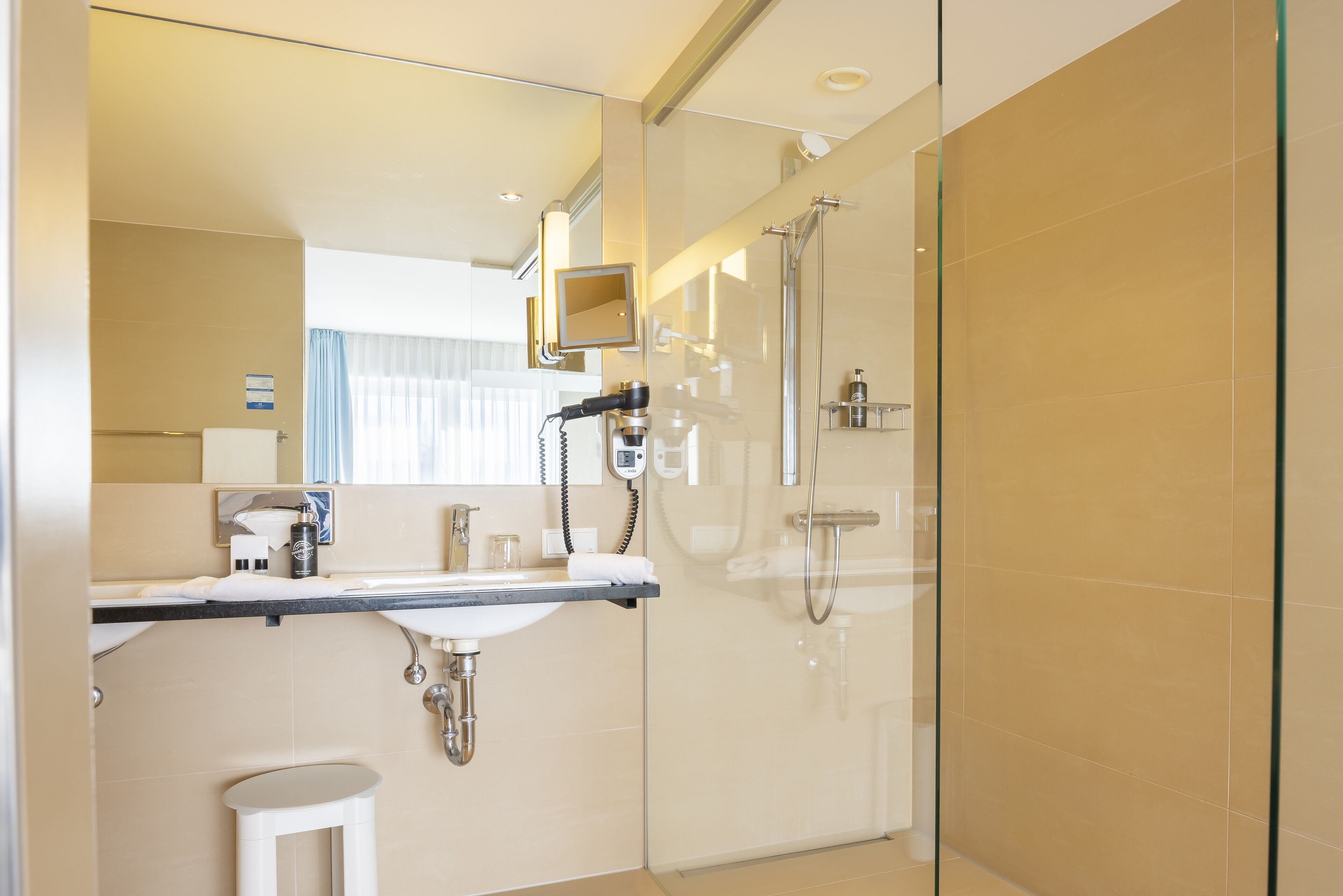 studio suite | bathroom | shower, rainfall showerhead, hair dryer, towels