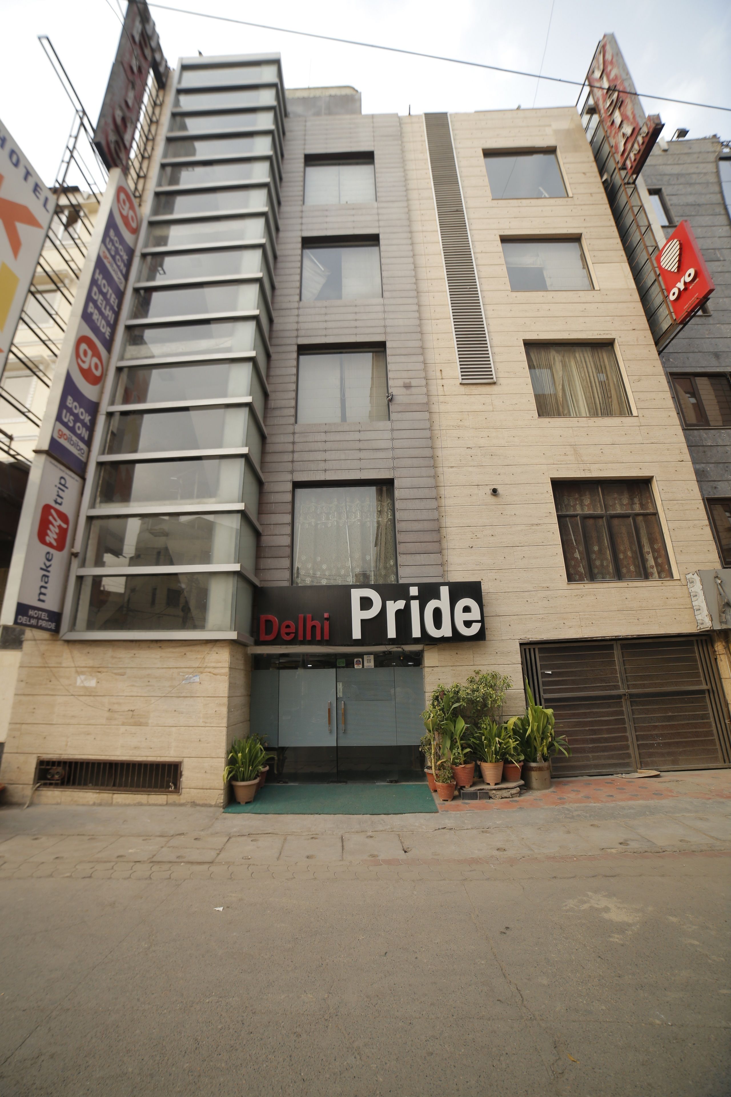 A building with a sign reading "Delhi Pride" and multiple windows.