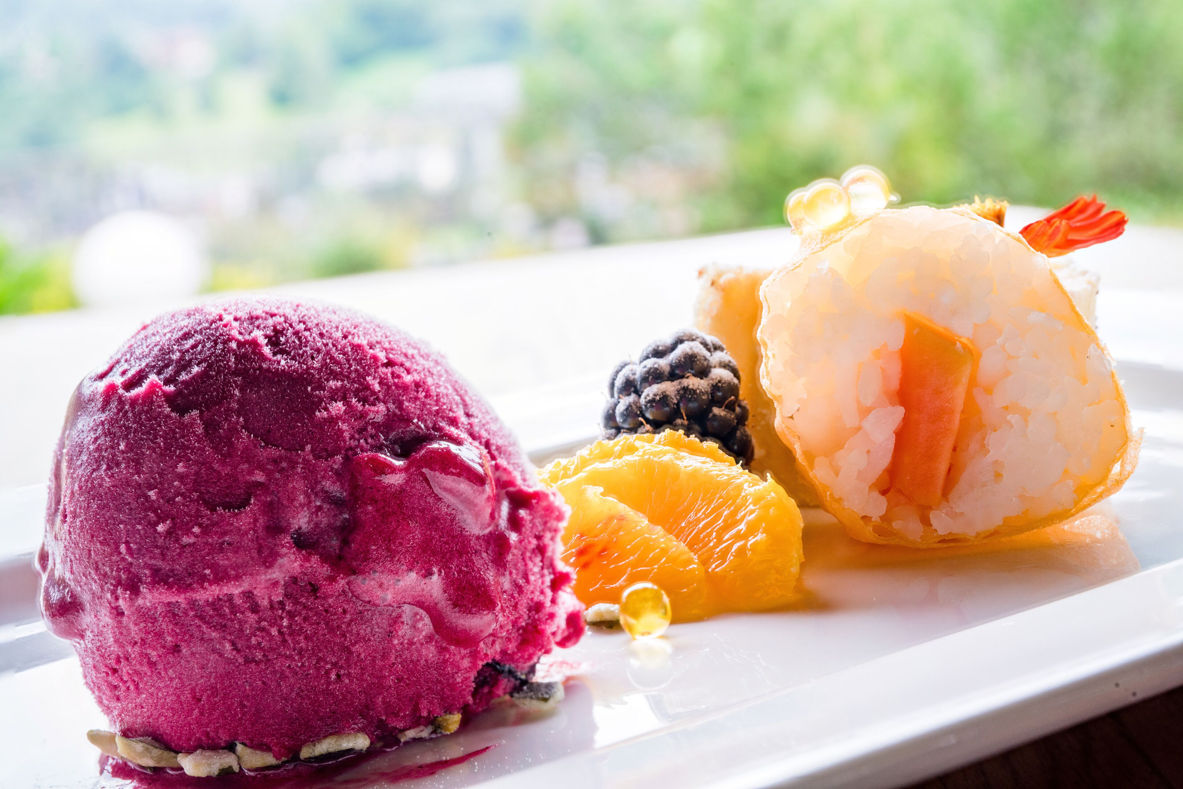 A dessert plate with ice cream and fruit.