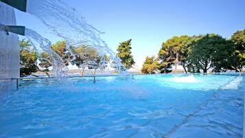 Seasonal outdoor pool, open 9 AM to 7 PM, pool umbrellas