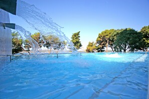 Seasonal outdoor pool, open 9 AM to 7 PM, pool umbrellas