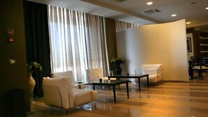 A spacious lobby with a checkered floor, a reception desk, and seating areas. - Tenuta Inagro (San Severo)