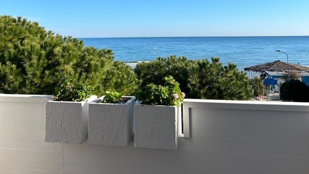 A balcony with a view of the sea and a building in the distance. - Hotel Giada (Silvi)