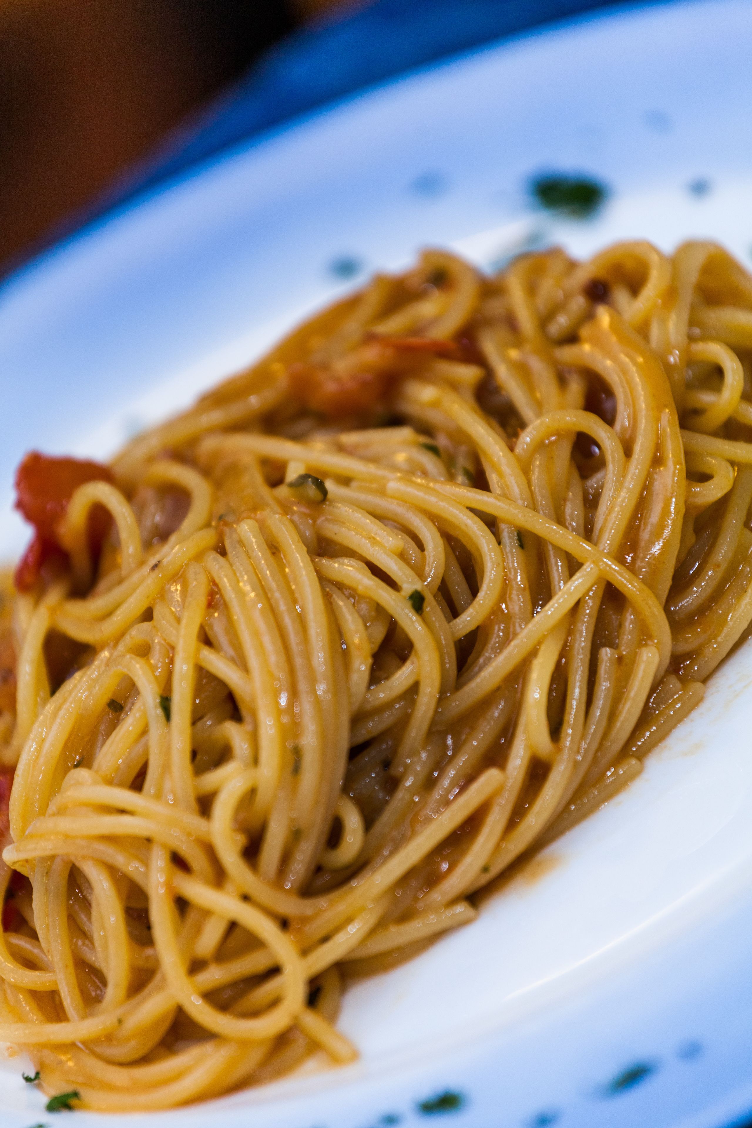 A plate of spaghetti with a tomato-based sauce.