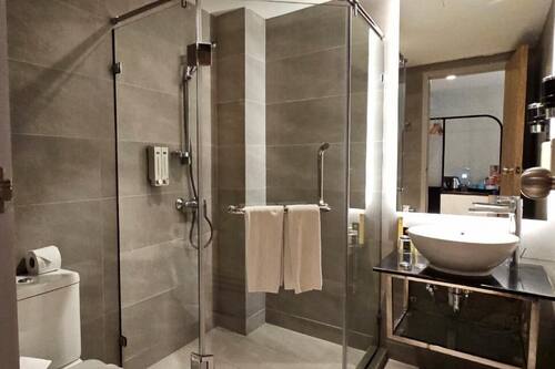 Shower, hair dryer, slippers, towels