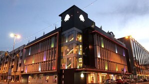 A modern building with large windows and a prominent entrance.