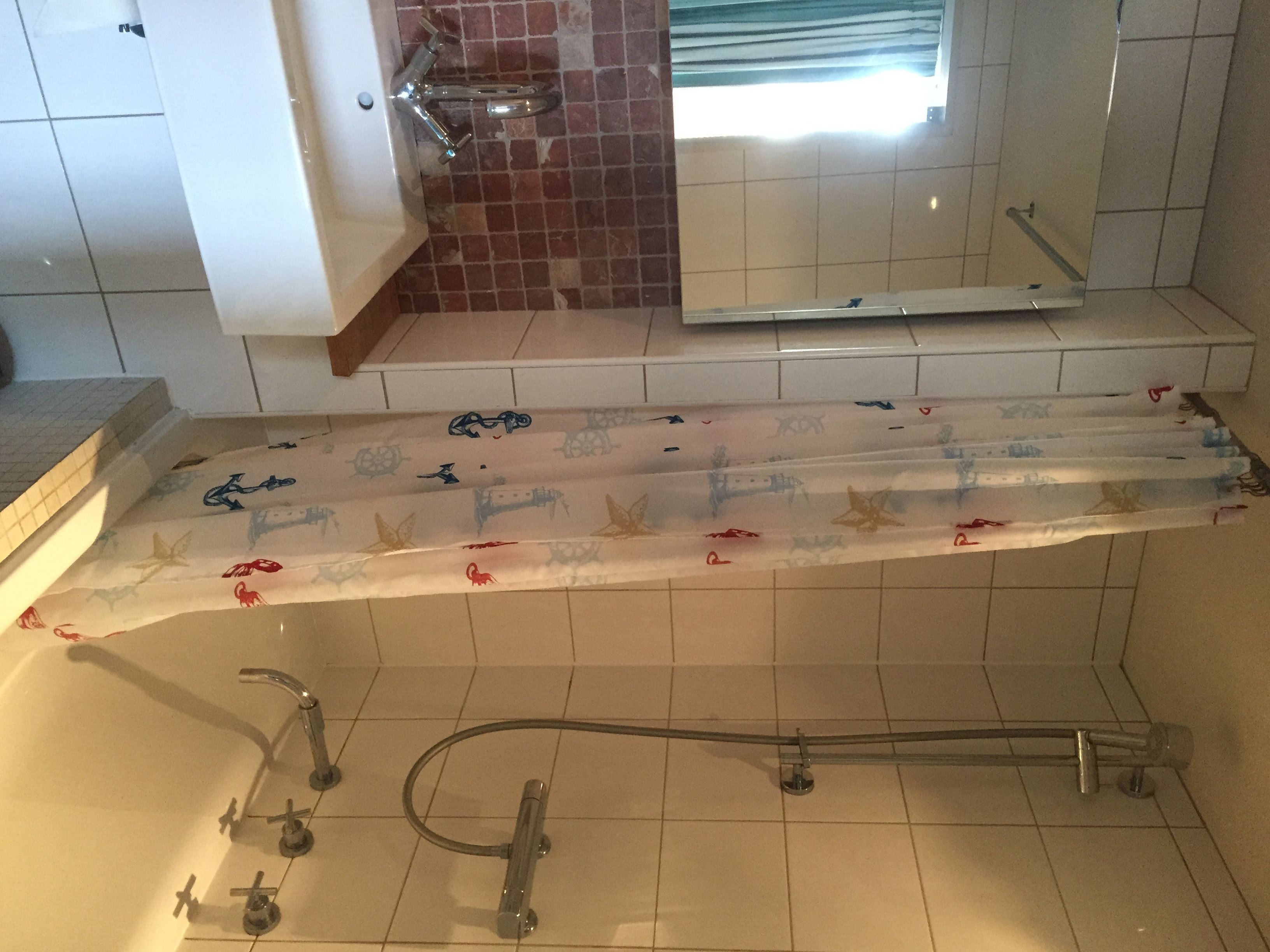 A bathroom with a bathtub, a shower, and a toilet.
