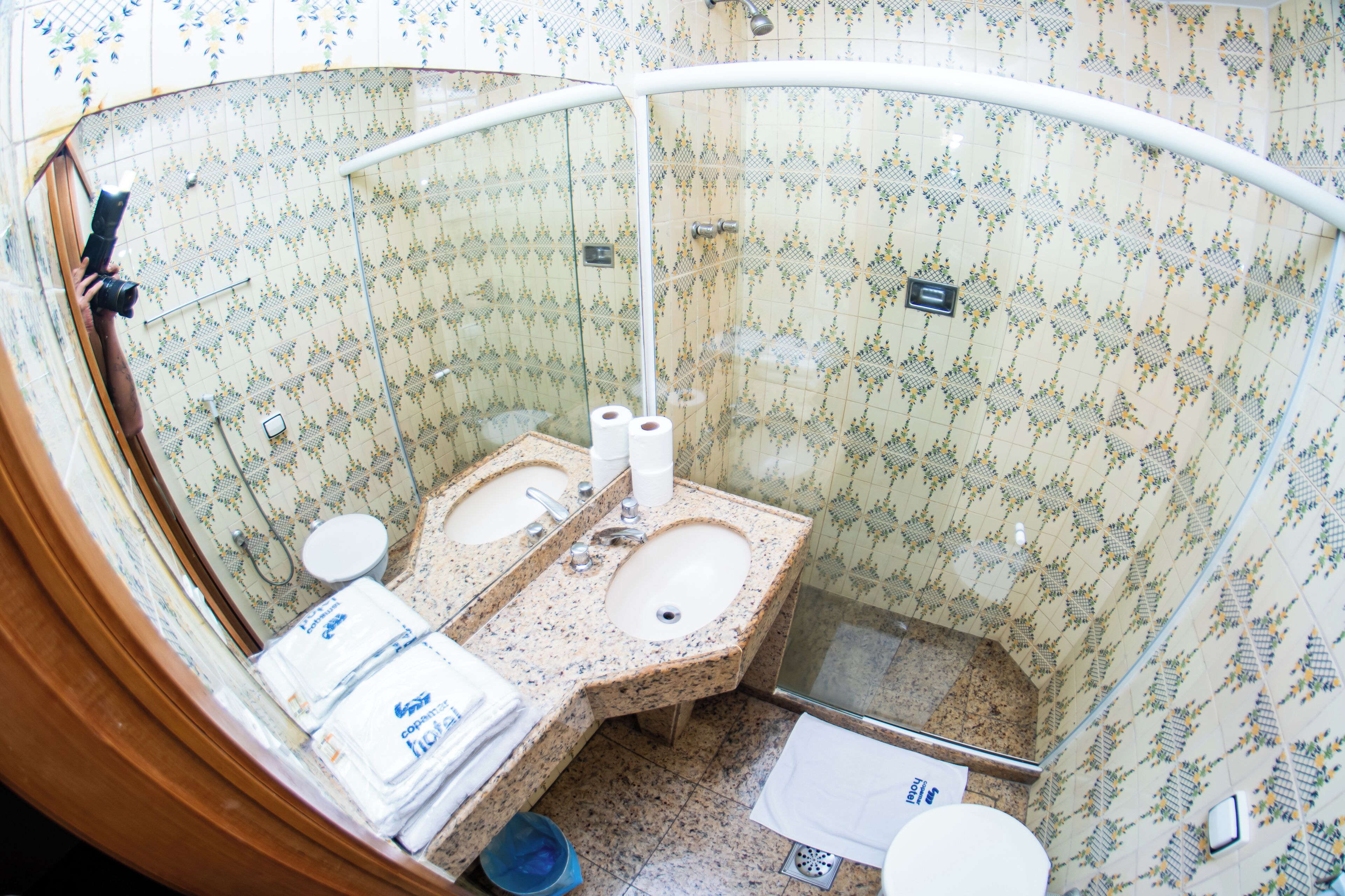 A bathroom with two sinks, a toilet, and a shower.